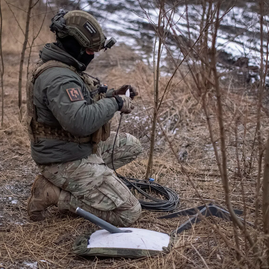 FILE PHOTO: A Ukrainian serviceman of 47th brigade prepares a Starlink satellite internet systems at his positions at a front line, amid Russia's attack on Ukraine, near the town of Avdiivka, recently captured by Russian troops in Donetsk region, Ukraine February 20, 2024. REUTERS/Inna Varenytsia/File Photo