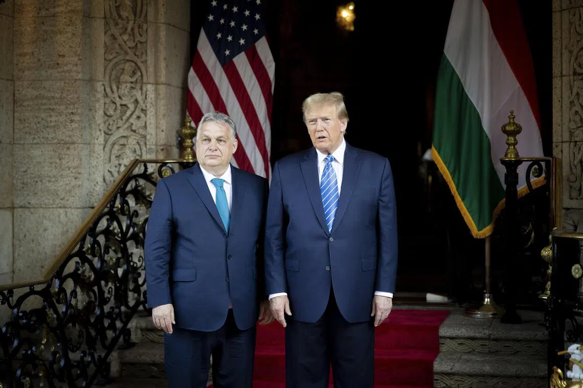 Former US President and Republican presidential candidate Donald Trump (right) and Hungarian Prime Minister Viktor Orban posing for photographers before their meeting at Trump's Mar-a-Lago estate in Palm Beach, Florida.