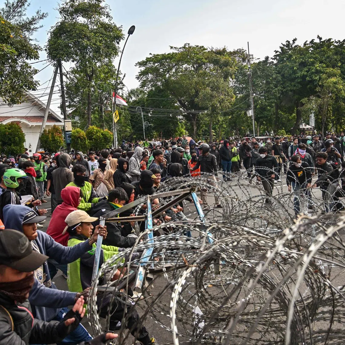 Demonstrators protest after the death of a motorbike taxi driver the previous night, in front of the governor's residence in Surabaya, on Aug 29.