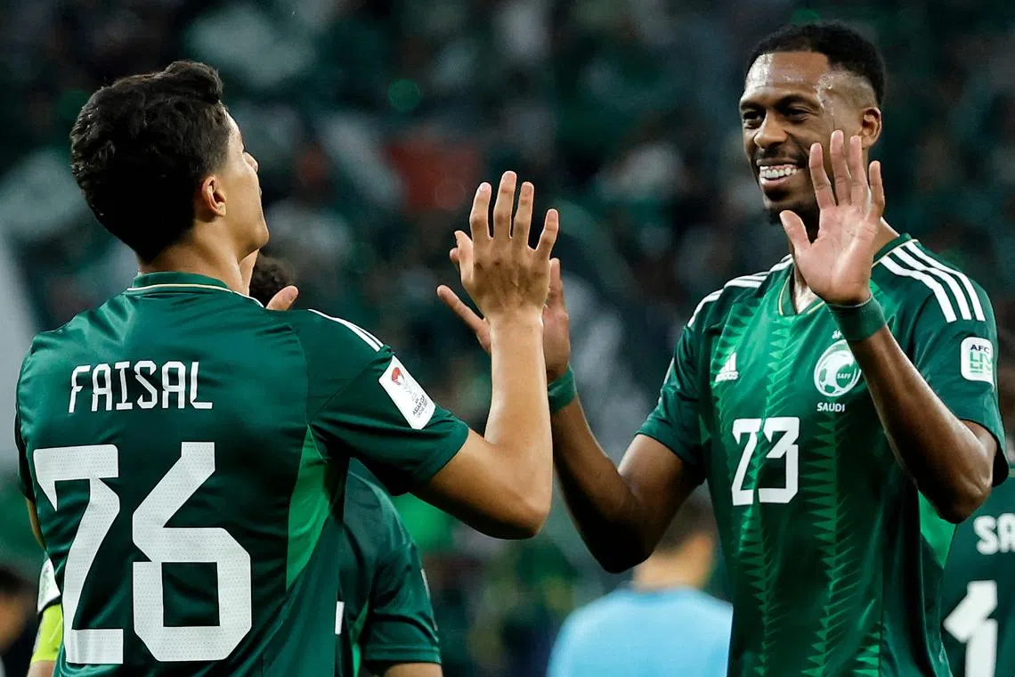 Midfielders Mohamed Kanno (right) and Faisal al-Ghamdi celebrate their goals for Saudi Arabia.