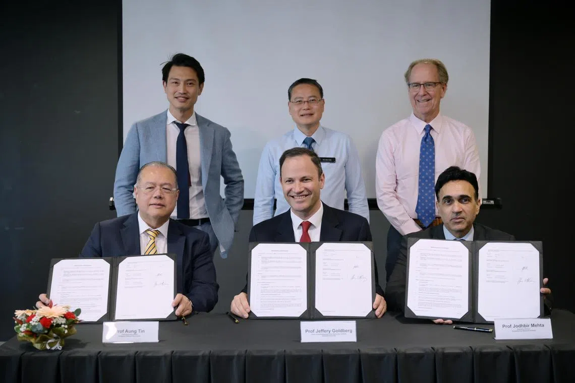 (Front row, from left) Singapore National Eye Centre (SNEC) chief executive Aung Tin; Byers Eye Institute chair of ophthalmology Jeffrey Goldberg; and Singapore Eye Research Institute (Seri) executive director Jodhbir Mehta with the MOU inked between the institutions on Nov 12. With them are: (back row, from left) SNEC senior consultant Daniel Ting; SingHealth Group CEO Ng Wai Hoe; and Duke-NUS Medical School dean Thomas Coffman.ST PHOTO: NG SOR LUAN