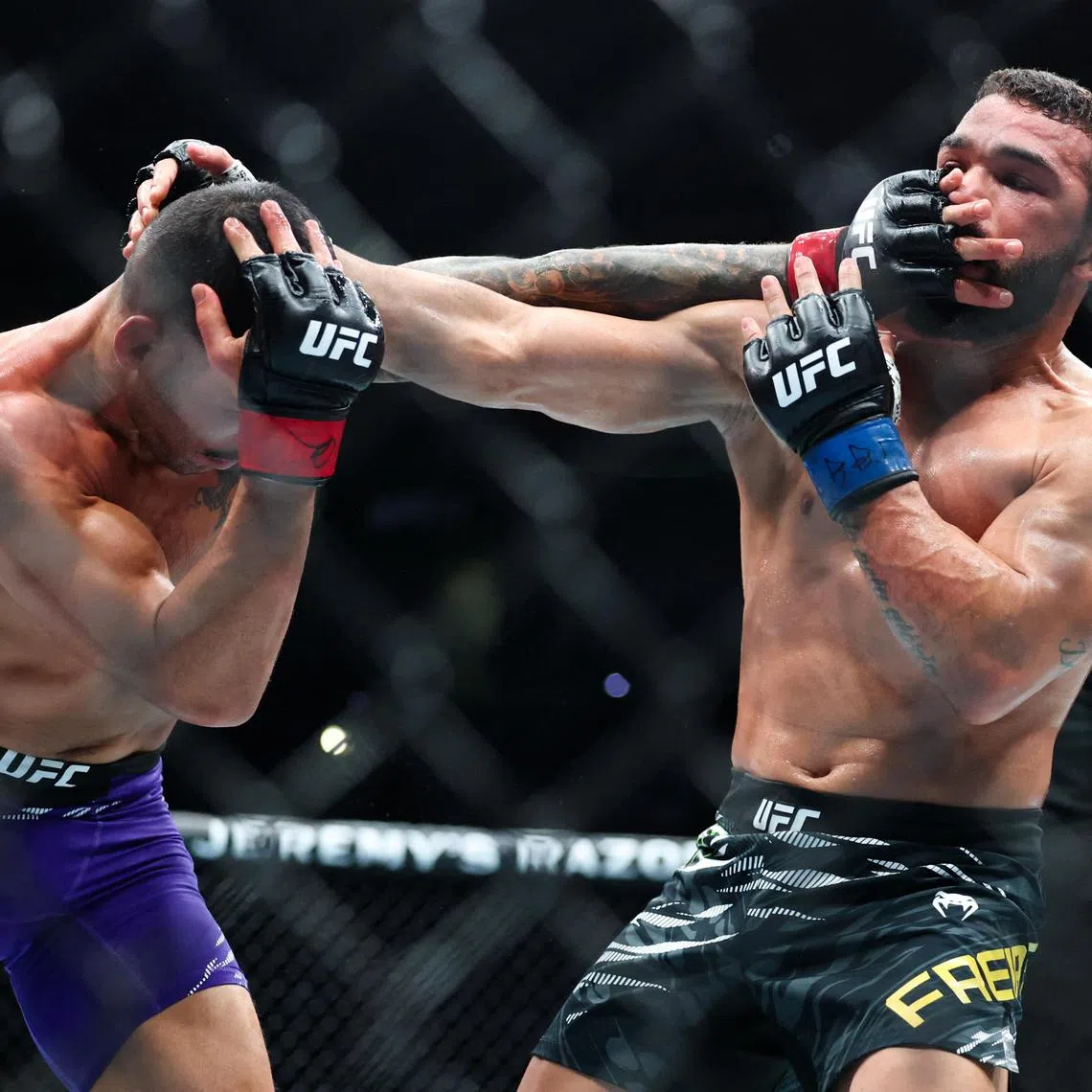 Patricio Pitbull (blue gloves) fighting Dan Ige in UFC 318 at Smoothie King Centre in New Orleans, Louisiana on July 19, 2025.