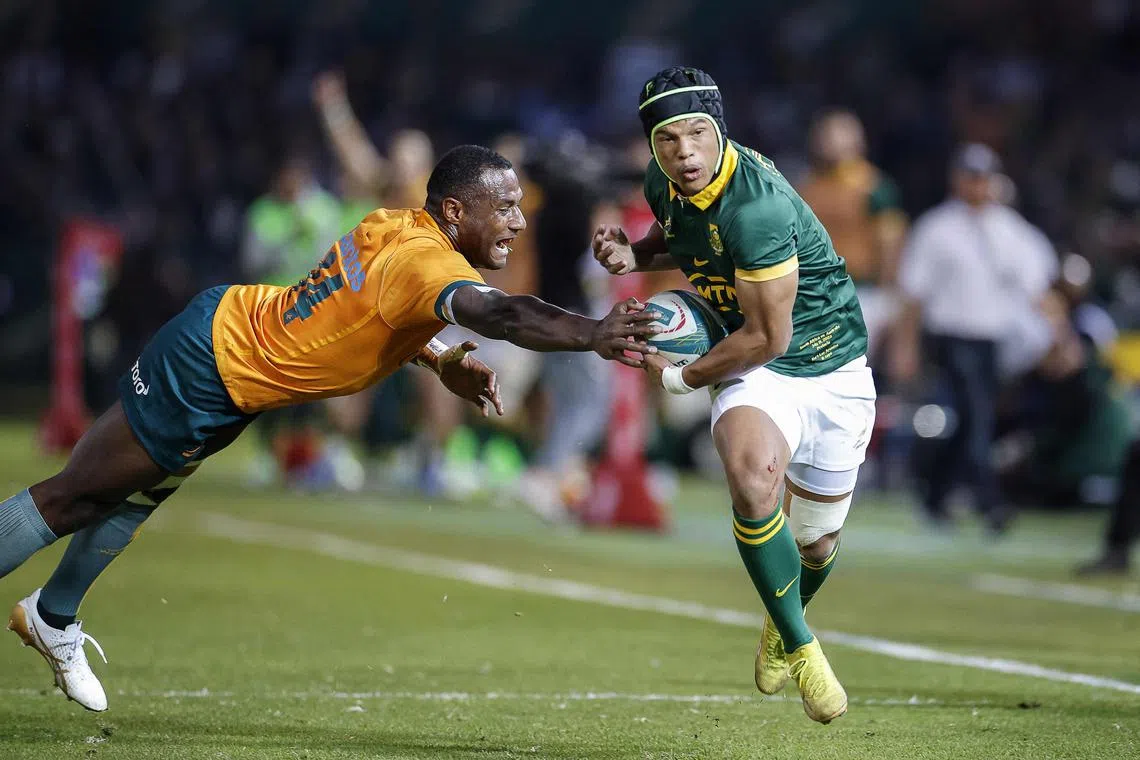 South Africa's winger Kurt-Lee Arendse evading Australia's wing Suliasi Vunivalu as he runs to score one of his three tries during the Rugby Championship first round match between South Africa and Australia at Loftus Versfeld stadium in Pretoria on Saturday. The Springboks won 43-12.
