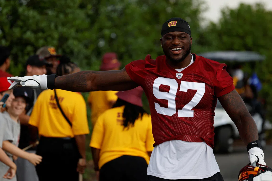 FILE PHOTO: Jul 27, 2023; Ashburn, VA, USA; Washington Commanders defensive end Efe Obada (97) gestures to fans while walking to the fields on day two of Commanders training camp at OrthoVirginia Training Center. Mandatory Credit: Geoff Burke-USA TODAY Sports/File Photo