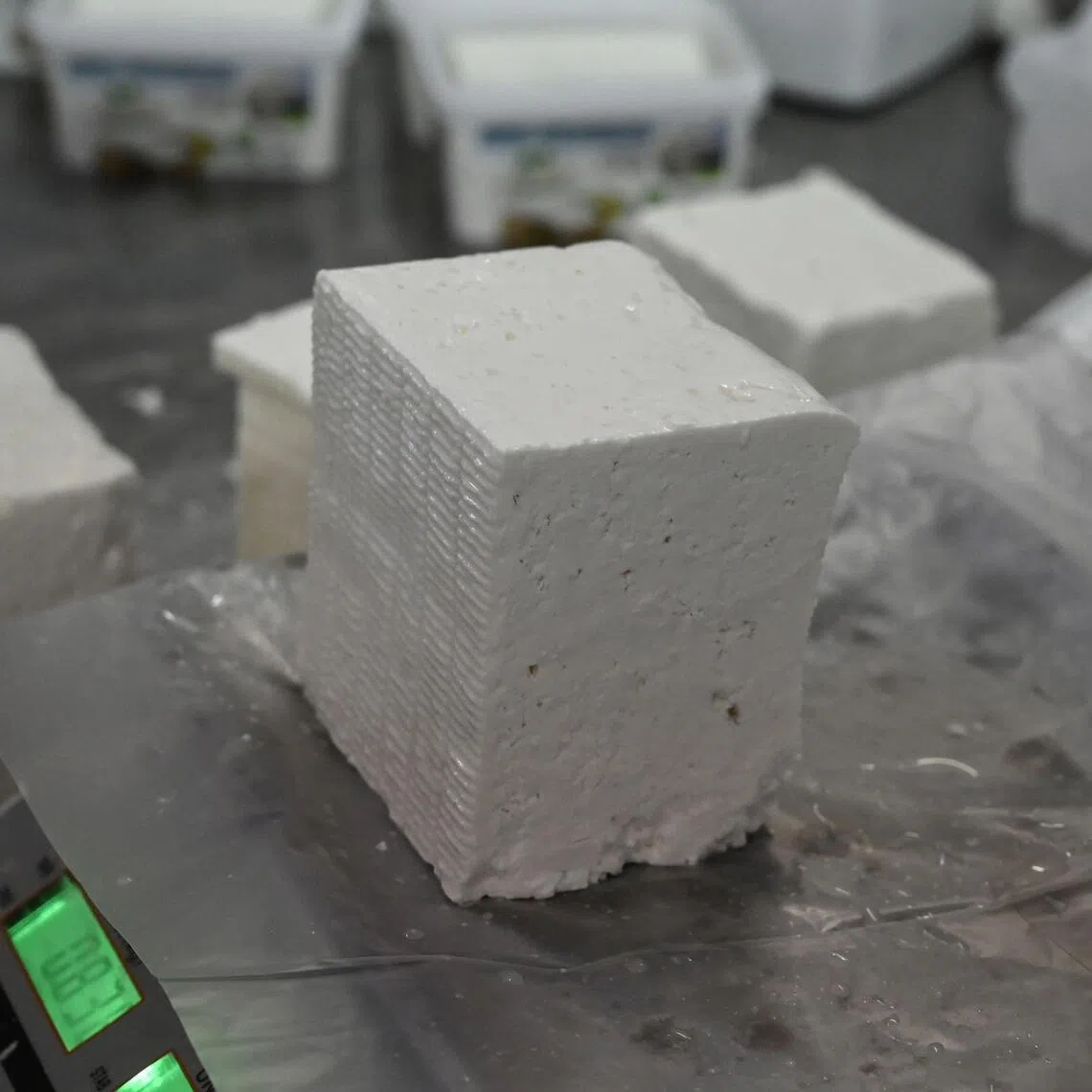 A piece of feta cheese being weighted and prepared at the Biologic farm of Giannis Panagiotidis in Stivos, a village near Thessaloniki, Greece. 