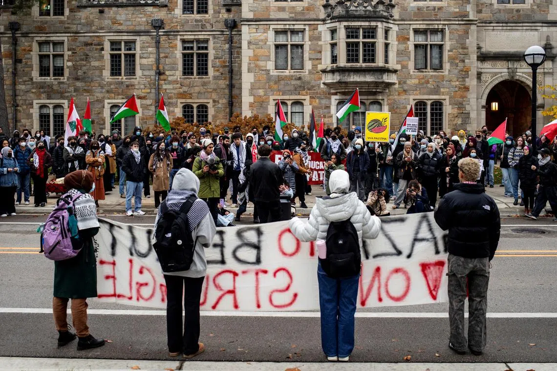 FILE PHOTO: Students and other individuals gather with signs during a protest to express support for Palestinians in Gaza, amid the Israel-Hamas conflict, in front of the residence of the University of Michigan's president in Ann Arbor, Michigan, U.S. November 21, 2024.  REUTERS/Emily Elconin/File Photo