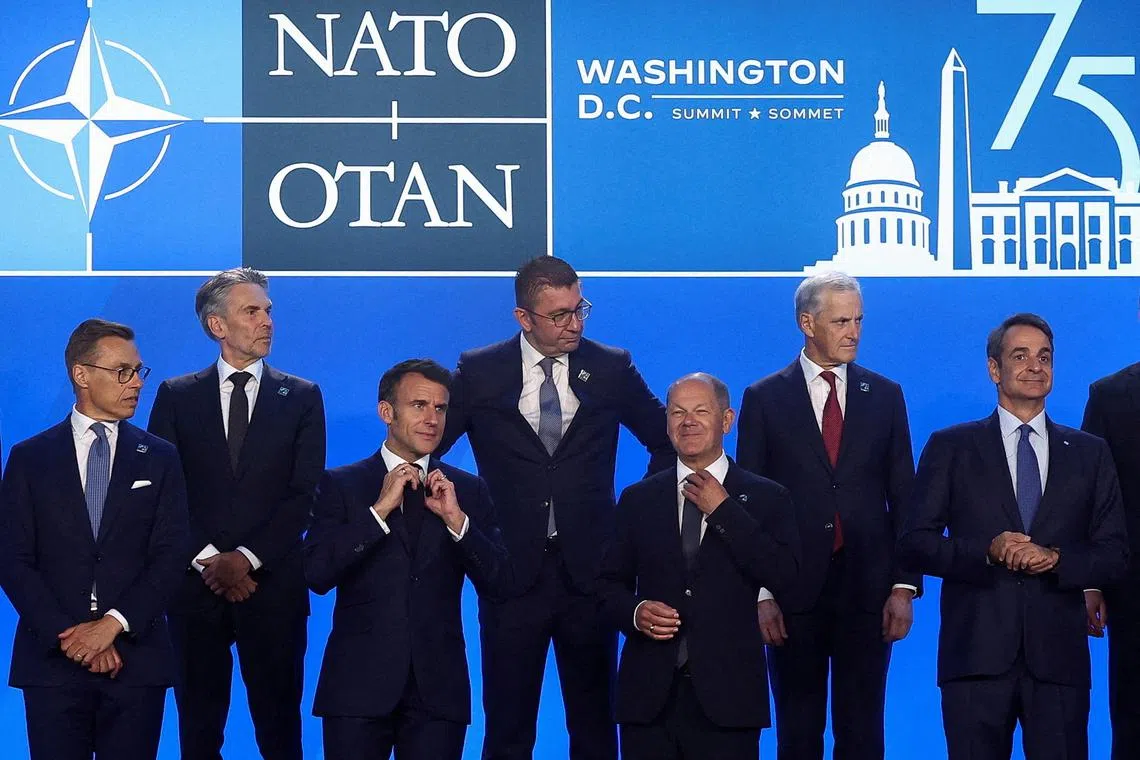 French President Emmanuel Macron, German Chancellor Olaf Scholz and Greek Prime Minister Kiriakos Mitsotakis stand together during NATO's 75th anniversary summit in Washington, U.S., July 10, 2024. REUTERS/Yves Herman