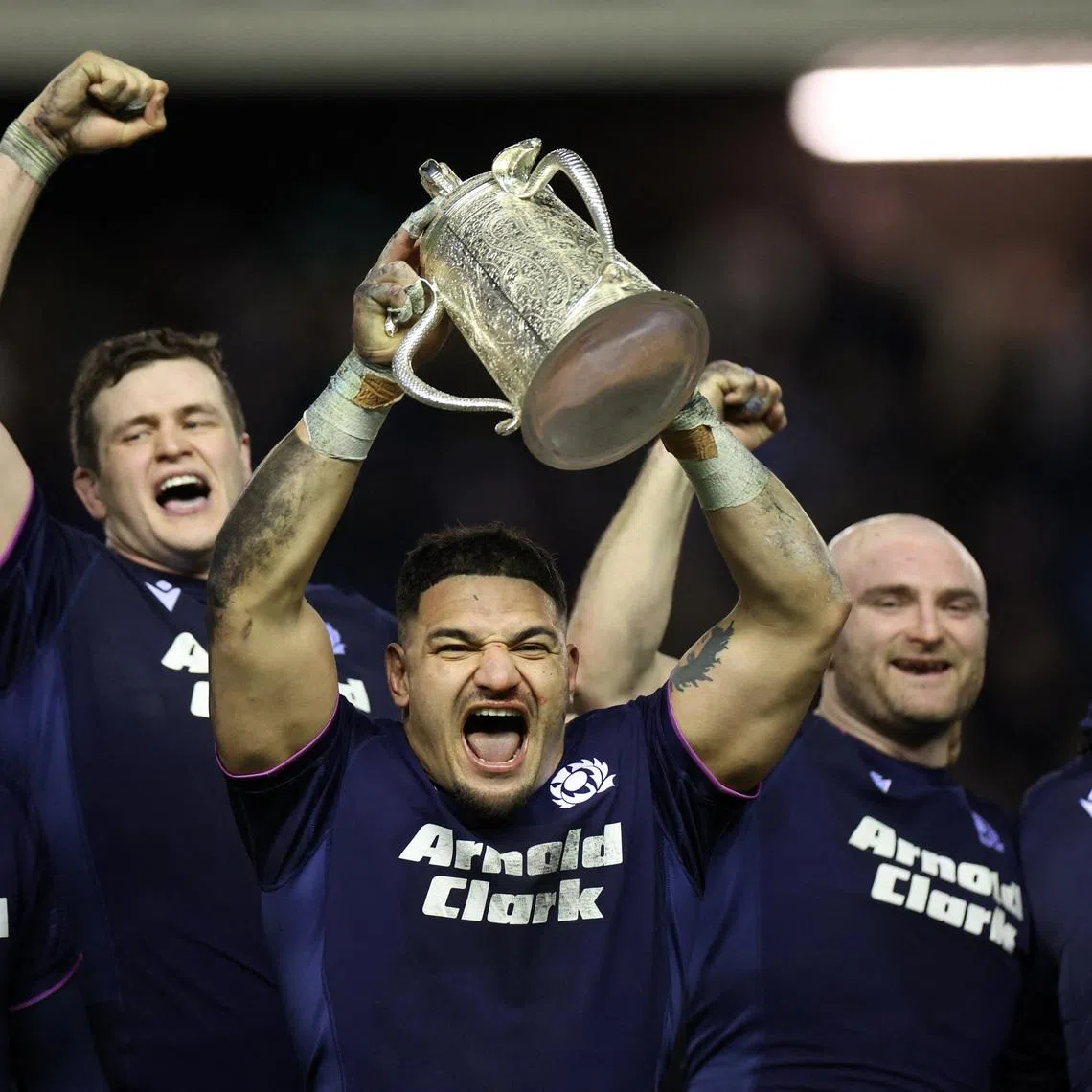 Rugby Union - Six Nations Championship - Scotland v England - Murrayfield Stadium, Edinburgh, Scotland, Britain - February 14, 2026 Scotland's Sione Tuipulotu lifts the Calcutta Cup trophy as he celebrates with teammates after victory over England REUTERS/Russell Cheyne
