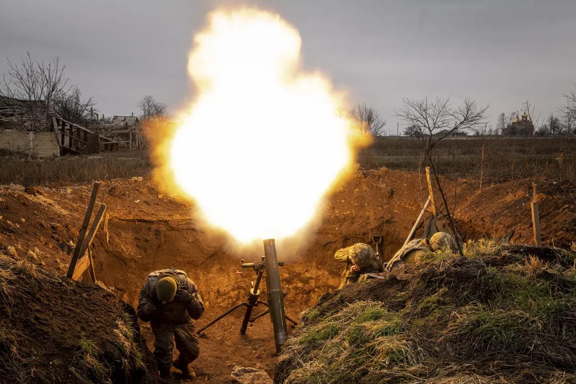 Ukrainian soldiers fire a mortar towards Russian positions in the Donetsk region of Ukraine, on Jan 1, 2023.