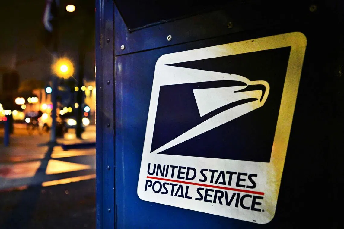 The United State Postal Service emblem is seen on the side of a mailbox in Monterey Park, California on February 4, 2025. The US Postal Service (USPS) said February 4, 2025 it was temporarily suspending inbound parcels from China and Hong Kong, shortly after President Donald Trump's imposition of fresh tariffs targeting Beijing. The halt will take place "until further notice," and follows Trump's order for an additional 10 percent levy on Chinese imports starting Tuesday. (Photo by Frederic J. BROWN / AFP)