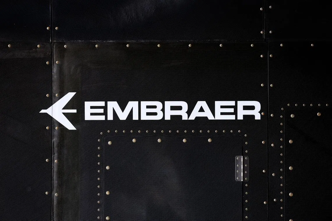 FILE PHOTO: The Embraer logo is seen at the full-scale prototype of an electric vertical take-off and landing (eVTOL) aircraft developed by Eve Air Mobility, an Embraer group company, as it is presented for the first time in Gaviao Peixoto, Brazil July 3, 2024. REUTERS/Amanda Perobelli/File photo