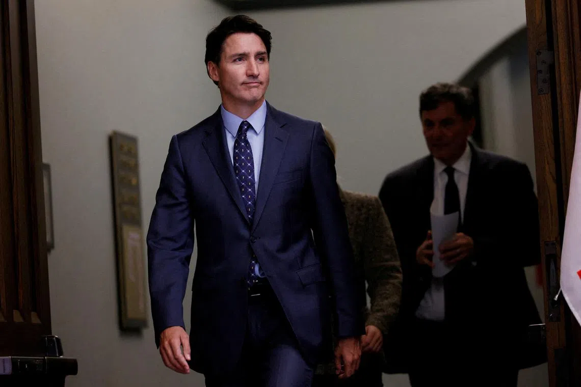 Canada's Prime Minister Justin Trudeau, with Minister of Foreign Affairs Melanie Joly, and Minister of Public Safety, Democratic Institutions and Intergovernmental Affairs Dominic LeBlanc, arrives to a press conference about the Royal Canadian Mounted Police's investigation into \"violent criminal activity in Canada with connections to India\",on Parliament Hill in Ottawa, Ontario, Canada October 14, 2024. REUTERS/Blair Gable