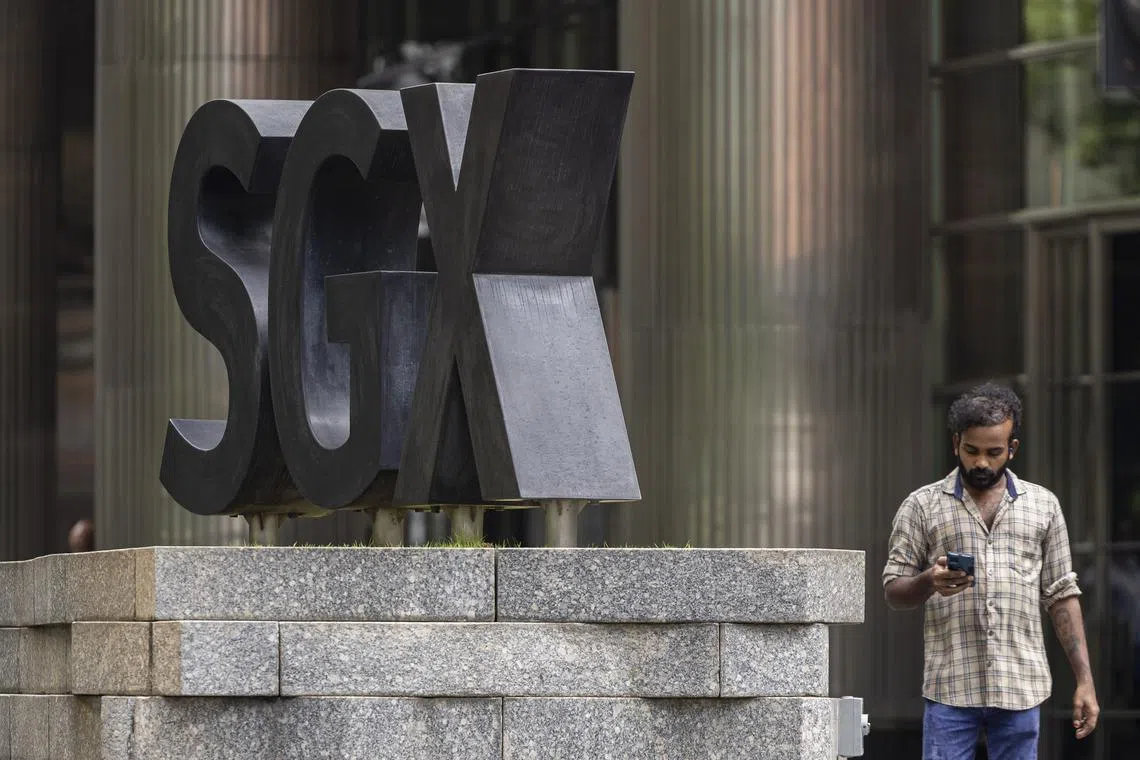ST20250609_202554200518/pixgenerics/Brian Teo/A passer-by walking past the SGX logo outside SGX Centre on June 9, 2025. Can be used for stories on SGX, stock market, STI, Trump, tariffs, investment, Singapore index, recession, shares. ST PHOTO: BRIAN TEO.