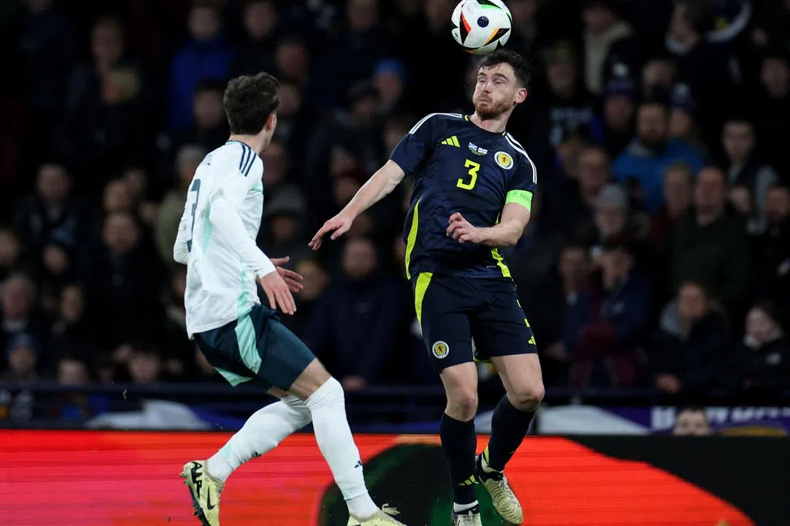Soccer Football - International Friendly - Scotland v Northern Ireland - Hampden Park, Glasgow, Scotland, Britain - March 26, 2024 Scotland's Andy Robertson in action with Northern Ireland's Trai Hume REUTERS/Russell Cheyne