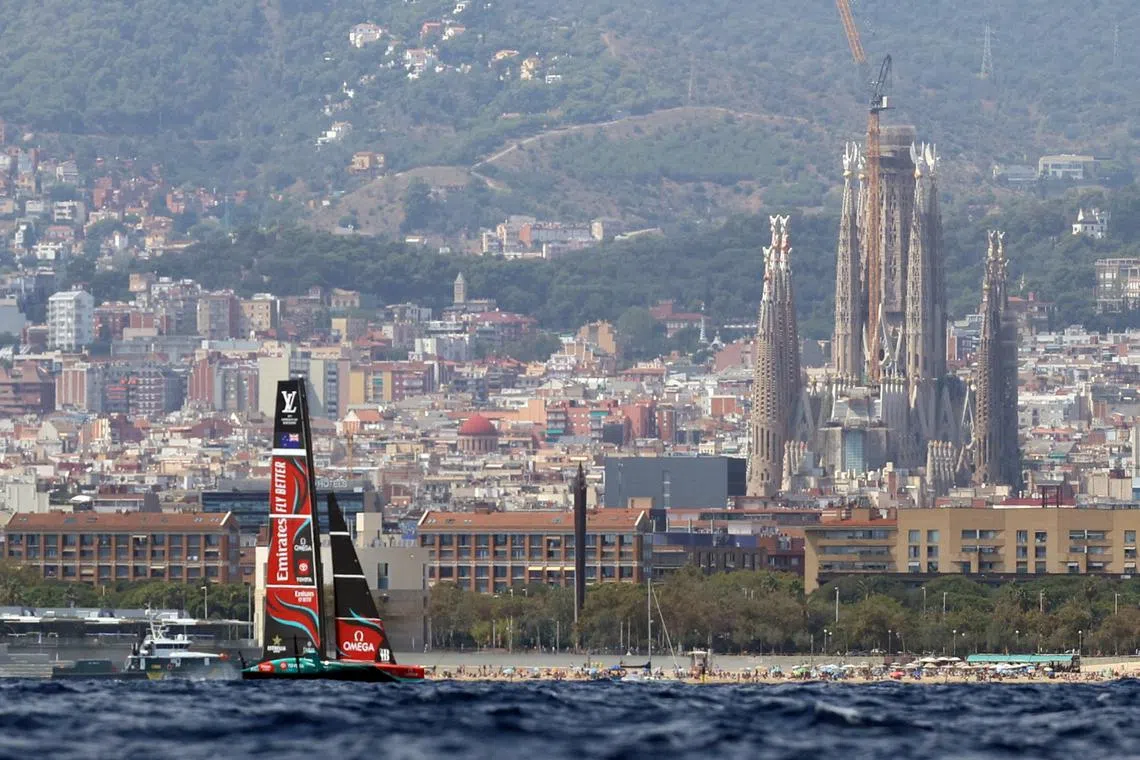 FILE PHOTO: Sailing - America's Cup Preliminary Regatta - Barcelona, Spain - August 25, 2024 Emirates Team New Zealand as they pass the Sagrada Familia REUTERS/Bruna Casas/File Photo
