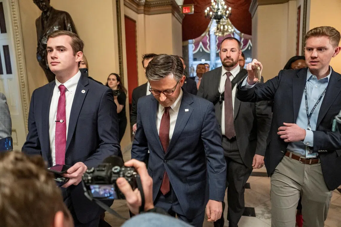 Speaker of the US House of Representatives Mike Johnson (centre) walks to the House floor from his office on Capitol Hill. 