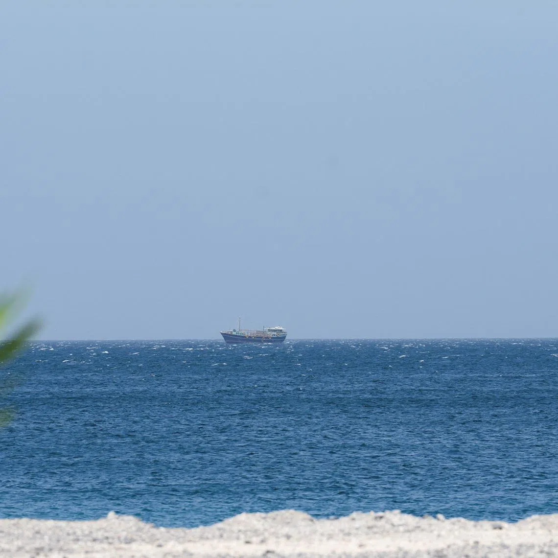 FILE PHOTO: A boat is off the coast of Musandam governorate, overlooking the strait of Hormuz, in Musandam governance, in Oman, April 8, 2026.REUTERS/Stringer/File Photo