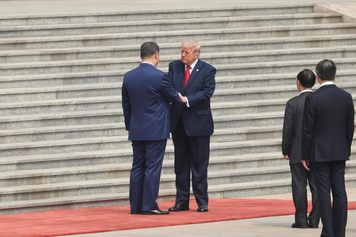 Chinese President Xi Jinping greets US President Donald Trump during a welcome ceremony at the Great Hall of the People in Beijing on May 14.
