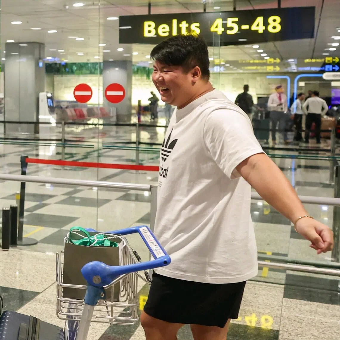 Mr Jason Low (right) was received by eight family members and friends at Changi Airport on March 8.