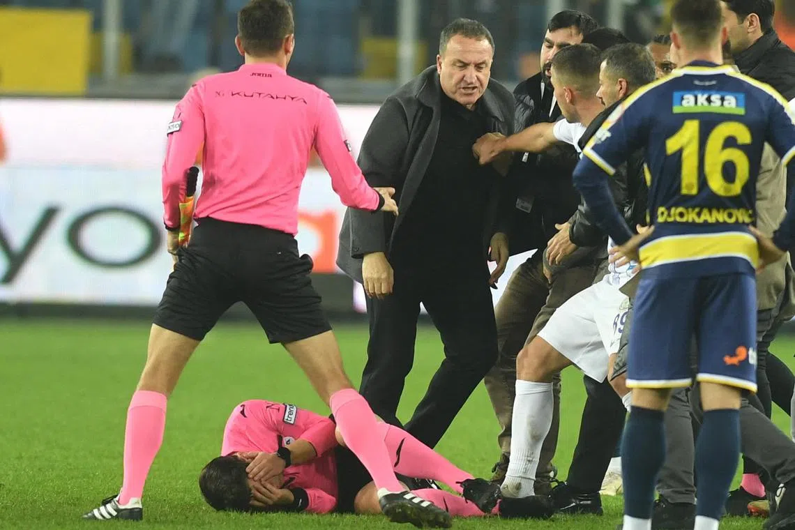 Ankaragucu President Faruk Koca reacting as referee Halil Umut Meler lies on the ground at the end of their Super Lig home match against Caykur Rizespor.