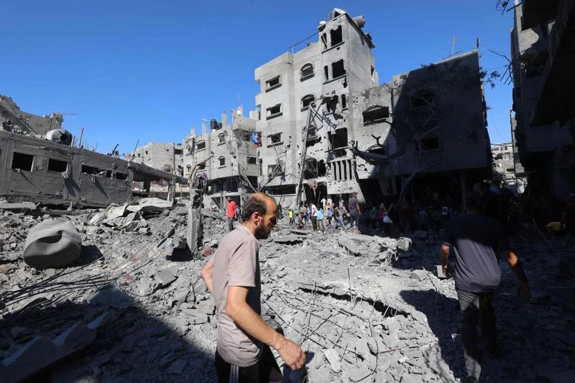 Palestinians inspect the damage after an Israeli strike in the Al-Bureij camp in the central Gaza Strip on July 4, 2025. (Photo by Eyad BABA / AFP)