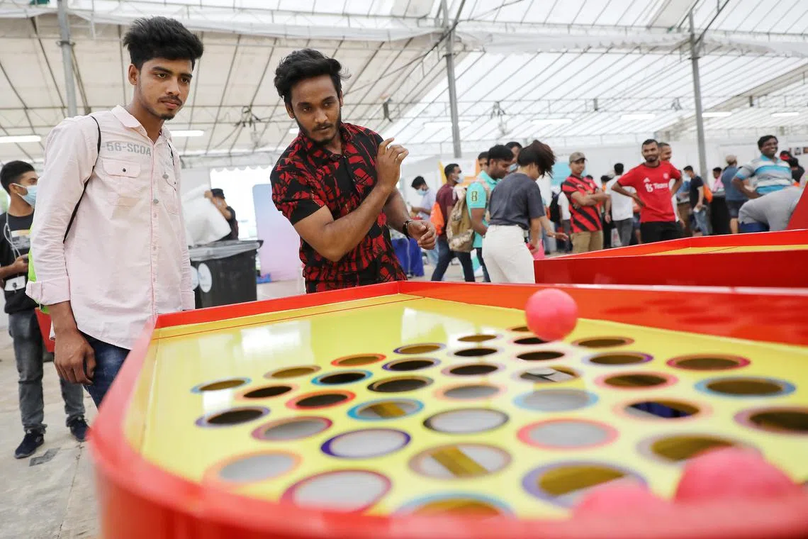 Migrant workers playing games at an International Migrants Day event in Little India on Dec 18, 2022.