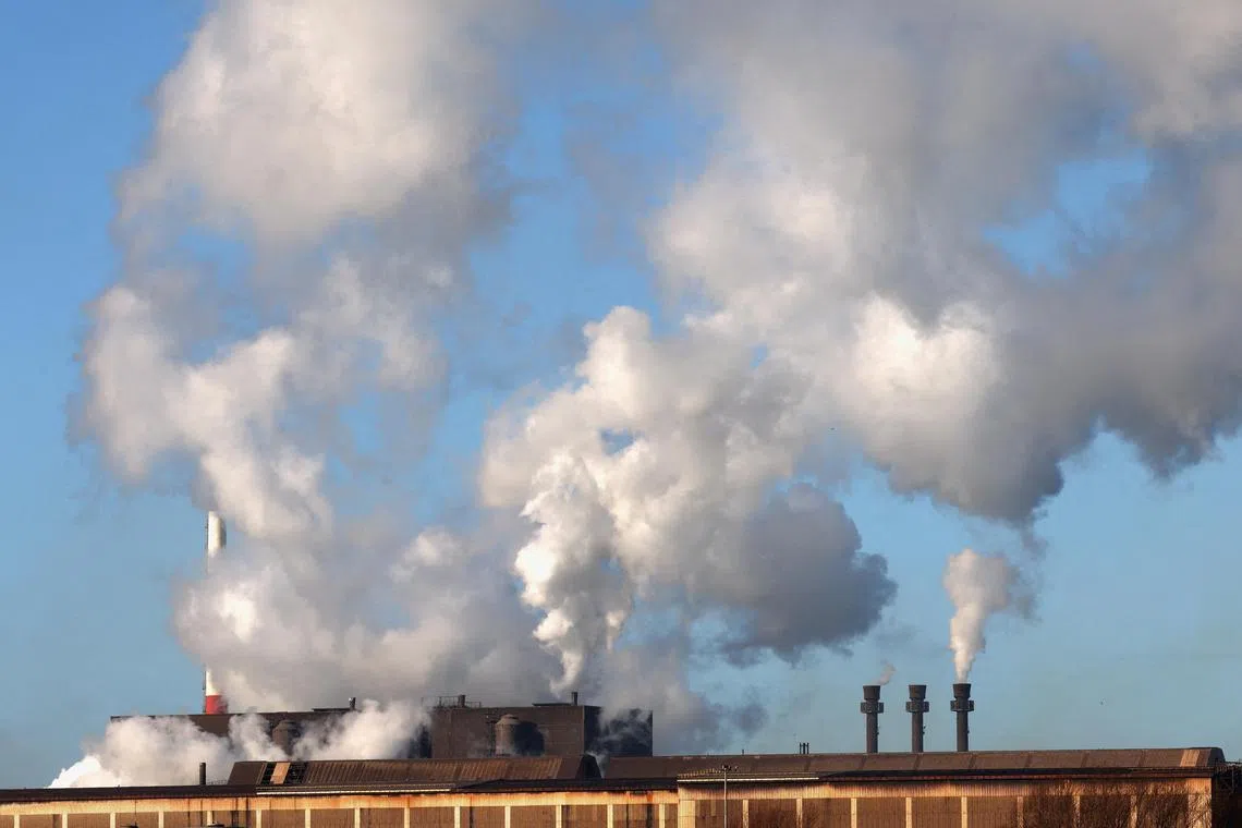 FILE PHOTO: Smoke rises from chimneys at a factory in the port of Dunkirk, France  January 19, 2023. REUTERS/Yves Herman/File Photo
