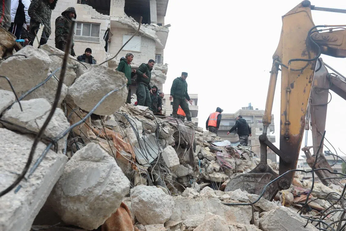 Syrian rescue teams search for survivors under the rubble after an earthquake in the government-controlled central Syrian city of Hama on Feb 6, 2023. 