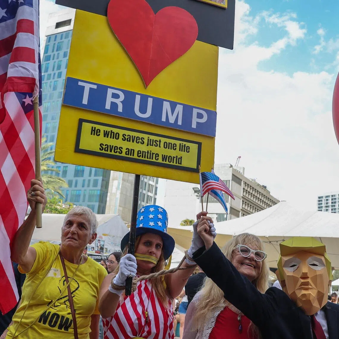 Israelis holding up a placard thanking US President Donald Trump following the announcement of a new Gaza ceasefire deal, in Tel Aviv on Oct 9.