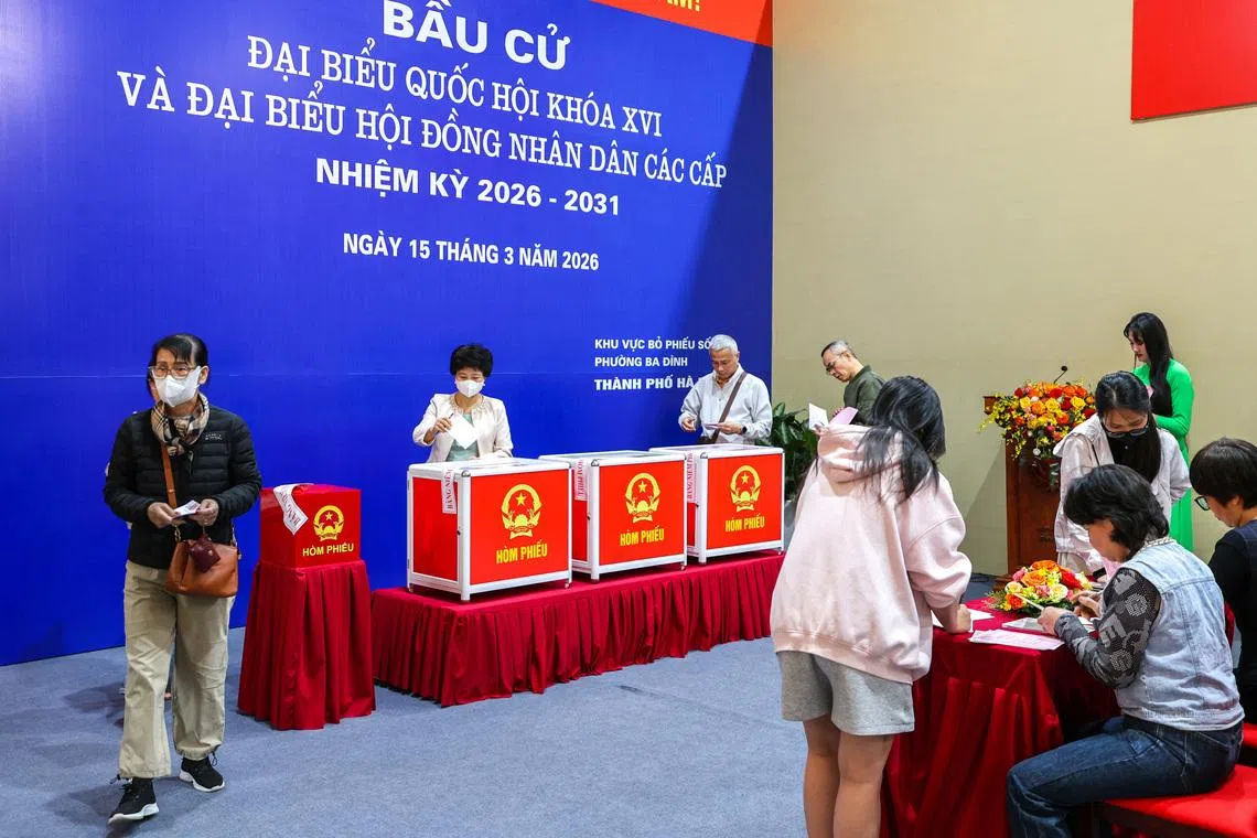 People vote at a polling station during a parliamentary election, in Hanoi, Vietnam, March 15, 2026.
