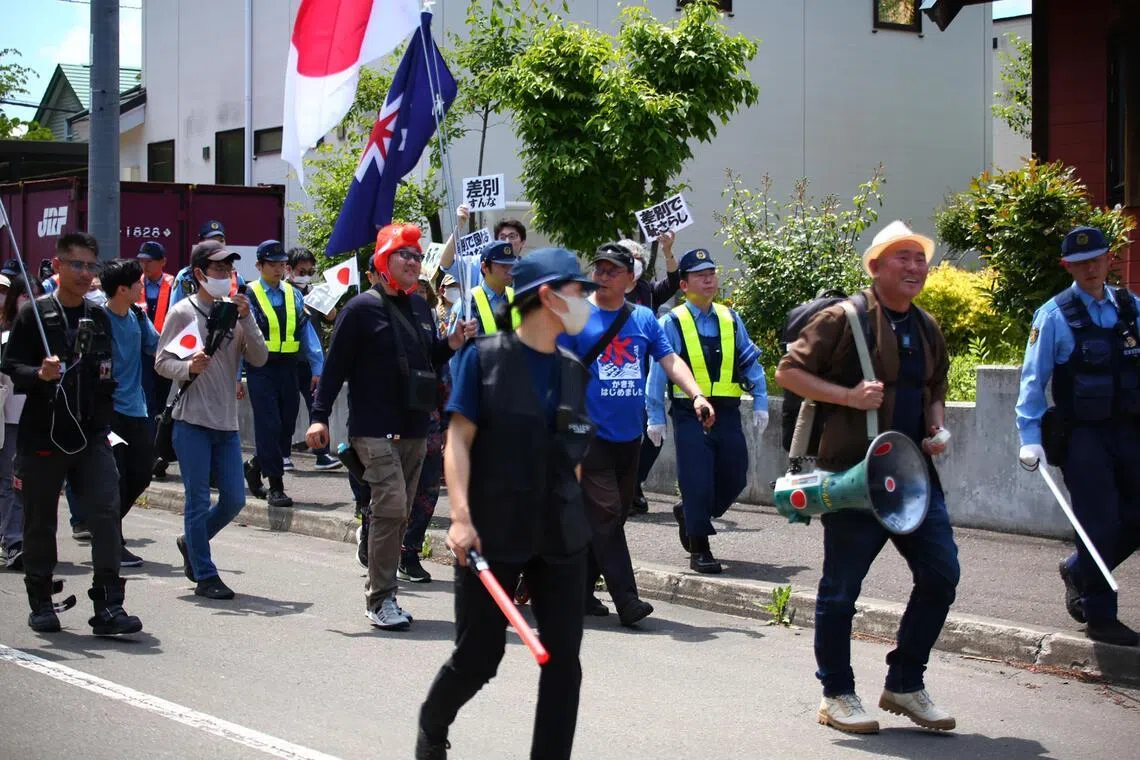 As protesters against the international school plan marched through the tranquil Tokiwa neighbourhood on June 14, anti-hate campaigners held up placards denouncing discrimination.