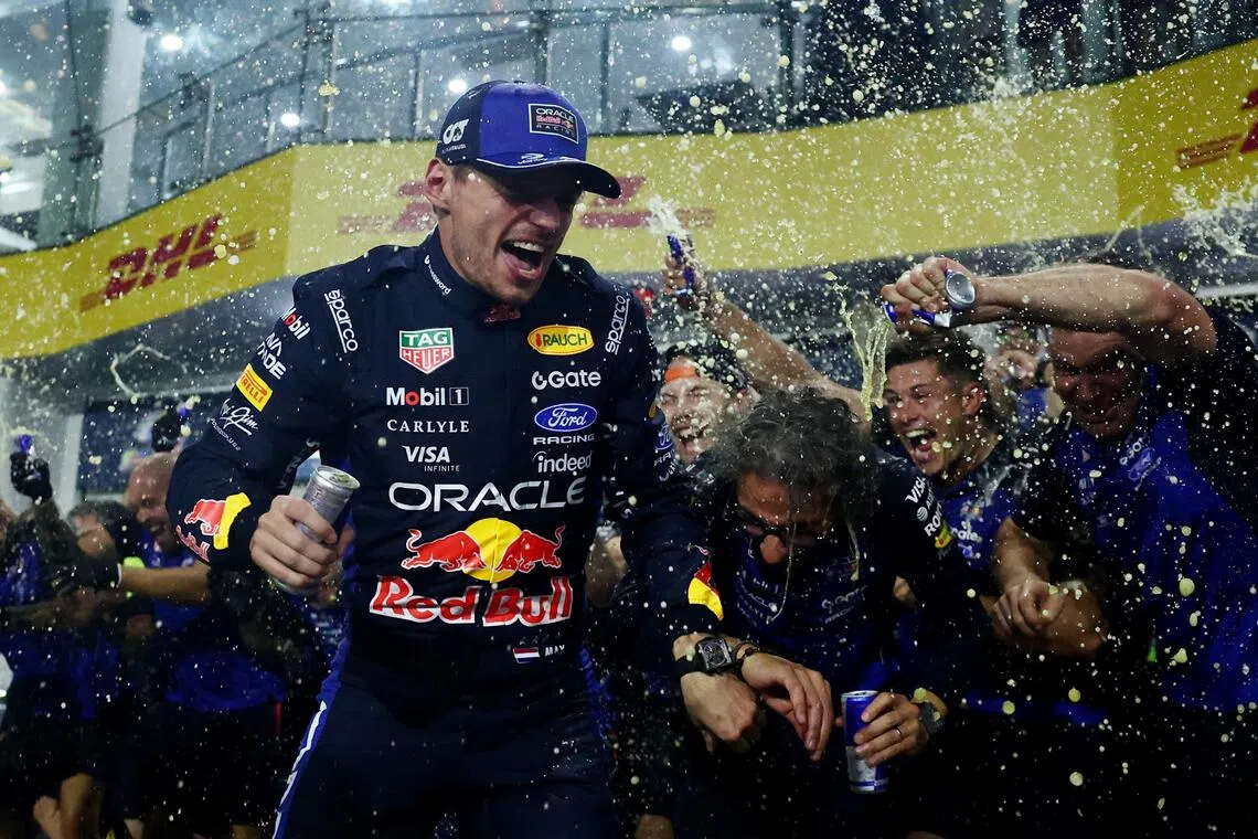 Red Bull’s Max Verstappen celebrating with team principal Laurent Mekies and his teammates after winning the Bahrain Grand Prix in Malaysia on Oct 4.