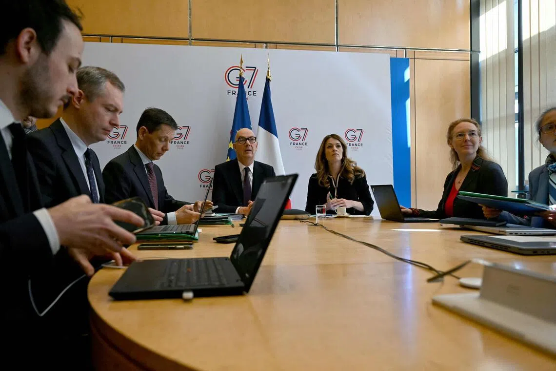 France's Economy and Finance Minister Roland Lescure and Energy Minister Maud Bregeon sit moments before hosting a video conference with the Group of Seven energy and finance ministers with central banks representatives in Paris on March 30.