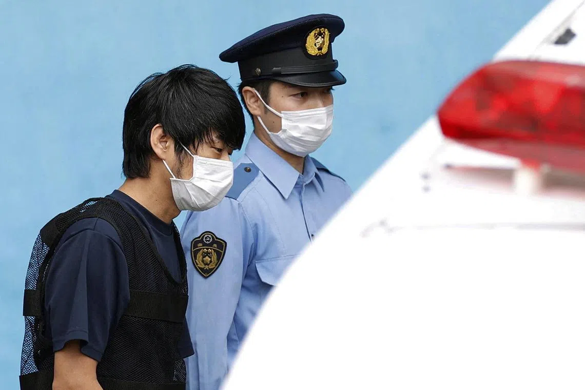 Tetsuya Yamagami, suspected of killing former Japanese premier Shinzo Abe, is escorted by a police officer as he is taken to prosecutors at Nara-nishi police station in Nara, western Japan, in this photo taken on Jul 10, 2022.