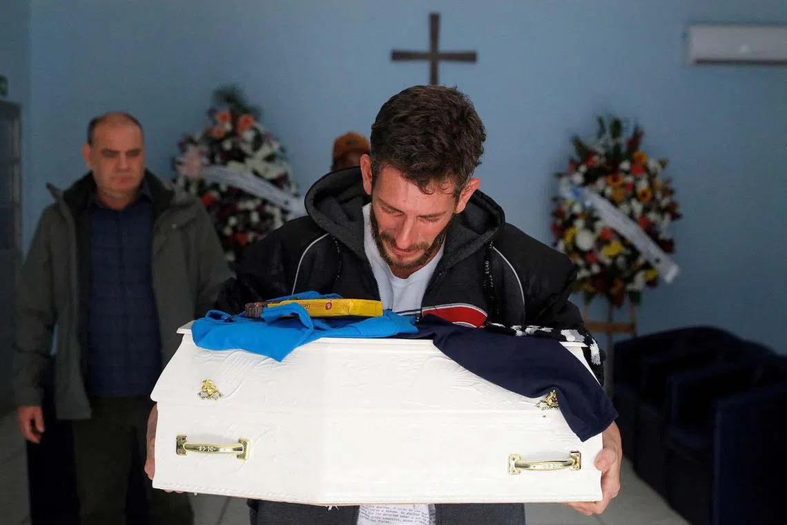 Flood survivor Miguel Rutigliano Bieleski cries during a funeral while carrying the coffin of his son Miguel Junior, a fatal victim of the passage of the extratropical cyclone that hit the region, in Lajeado, Brazil, Sept 11.