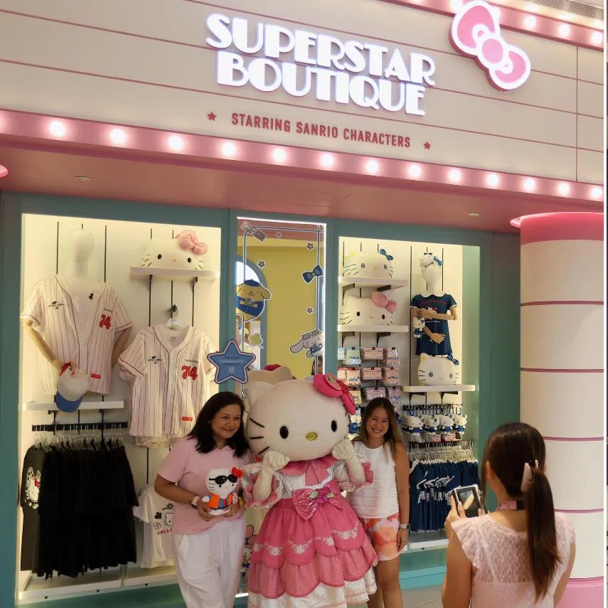 Visitors take photos with Hello Kitty during a meet-and-greet at the Superstar Boutique, and visitors queuing for food at the Hello Kitty themed Superstar Cafe.