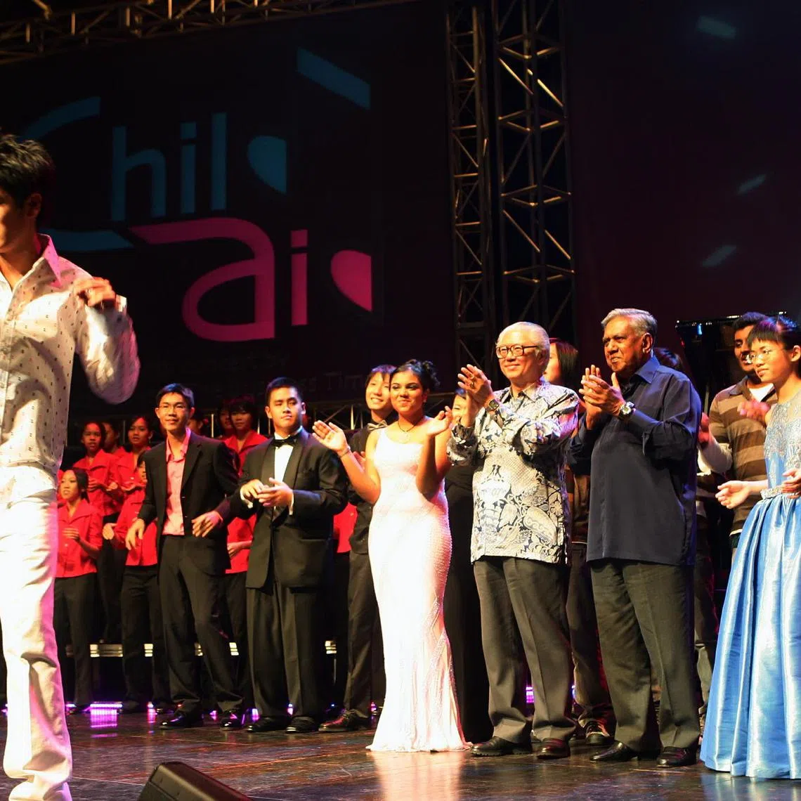 [Nathan Hartono (left), 15, singing at the ChildAid concert, showcasing Singapore's young musical talents. The concert was organised by The Straits Times and The Business Times, raising $335,000 
for the ST School Pocket Money and BT Budding Artists funds. Last night was for corporate sponsors and invited guests, with President S R Nathan as the guest of honour and it was held at the University Cultural Centre. ]