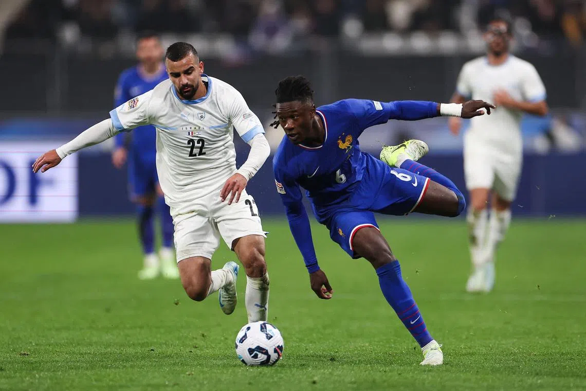 Israel midfielder Mahmoud Jaber fights for the ball with France's midfielder Eduardo Camavinga.