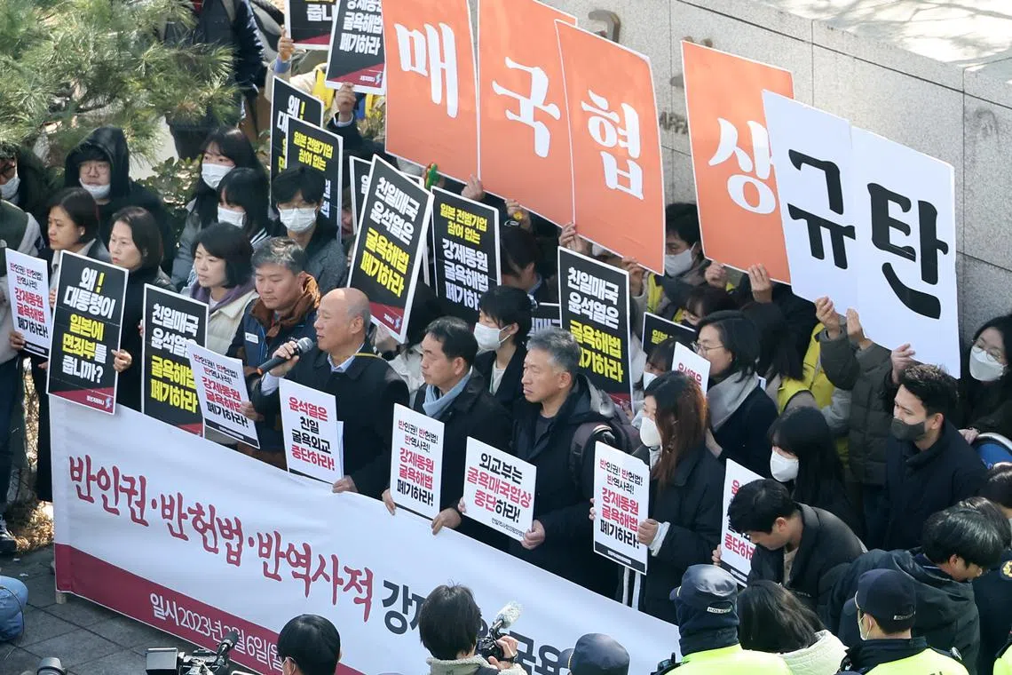 Members of a progressive activist group stage a rally in front of the foreign ministry in Seoul, South Korea, on March 6, 2023.