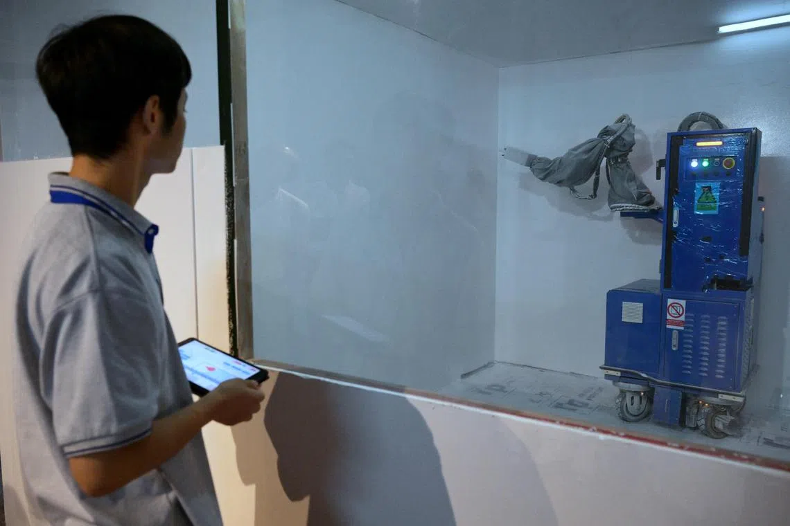 A robot used for painting walls from Legend Robot Technology Co., Ltd at BCA's Robotics Technology Exchange on Aug 30, 2024. BCA is showing robots used in construction at the exchange. 