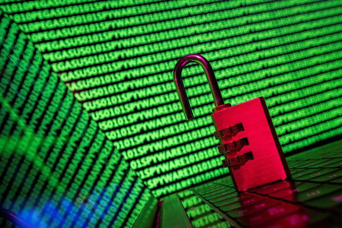 FILE PHOTO: A padlock is seen in front of the word 'spyware' and binary code in this illustration taken May 4, 2022. REUTERS/Dado Ruvic/Illustration/File Photo