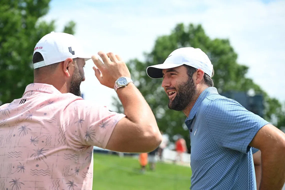 Jon Rahm of Spain and Scottie Scheffler of the United States talk during a practice round prior to the 2024 PGA Championship at Valhalla Golf Club.