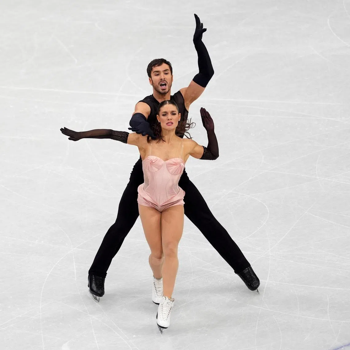 Feb 9, 2026; Milan, Italy; Laurence Fournier Beaudry and Guillaume Cizeron skate during ice dancing at the Milano Cortina 2026 Olympic Winter Games at Milano Ice Skating Arena. Mandatory Credit: Amber Searls-Imagn Images