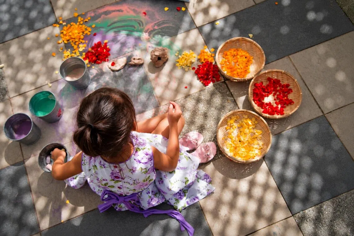 A child explores colour, texture and nature at hr own pace through sensory play.