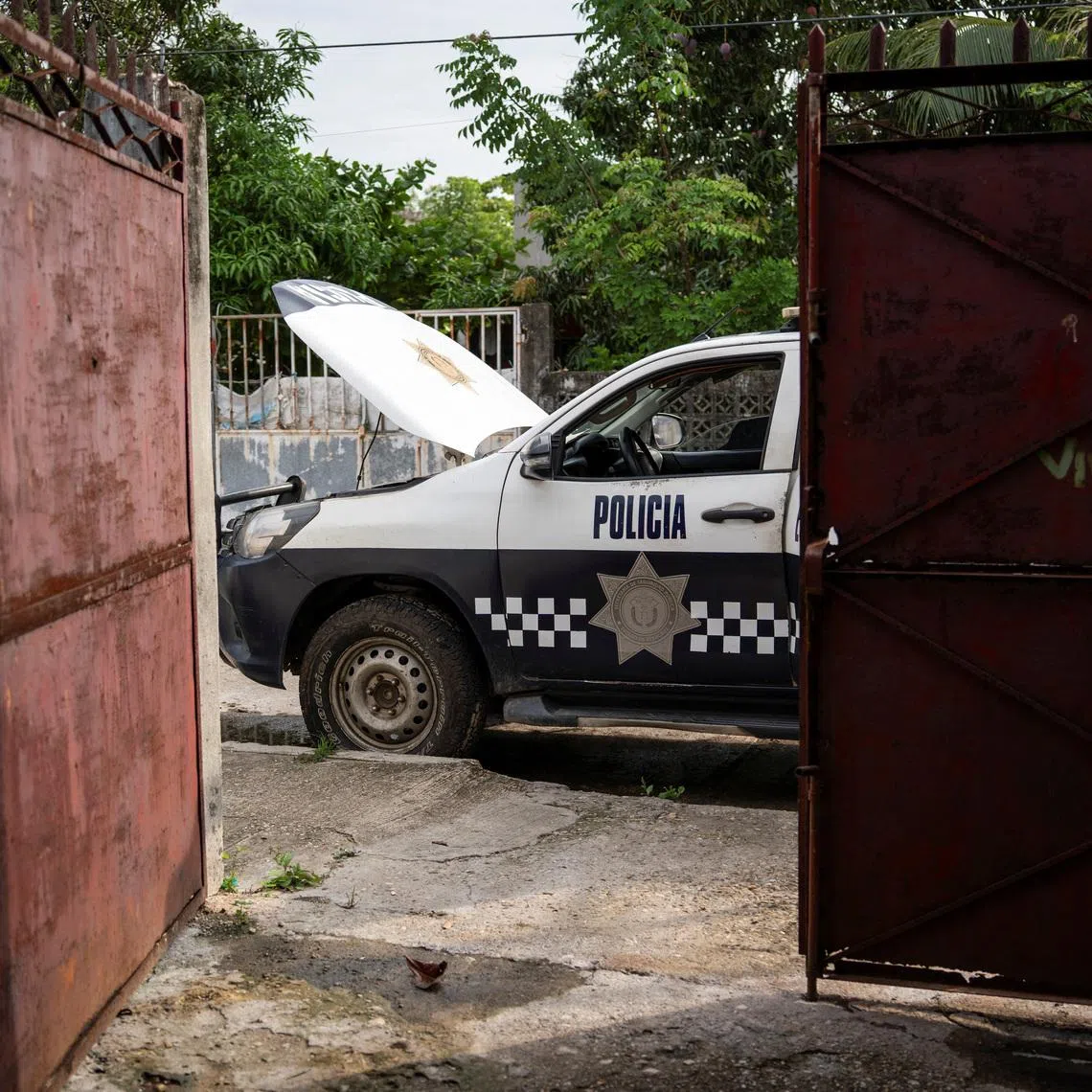 A police vehicle stands outside the home of journalist Roxana Guzman, who was abducted by unidentified armed men at her residence on June 2, in Nanchital, Veracruz state, Mexico, June 12, 2026. REUTERS/Angel Hernandez