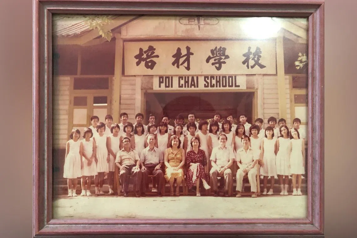 Associate Professor Loh Chin Ee's grandmother is seated in the front row (third from left) in a sleeveless yellow dress.