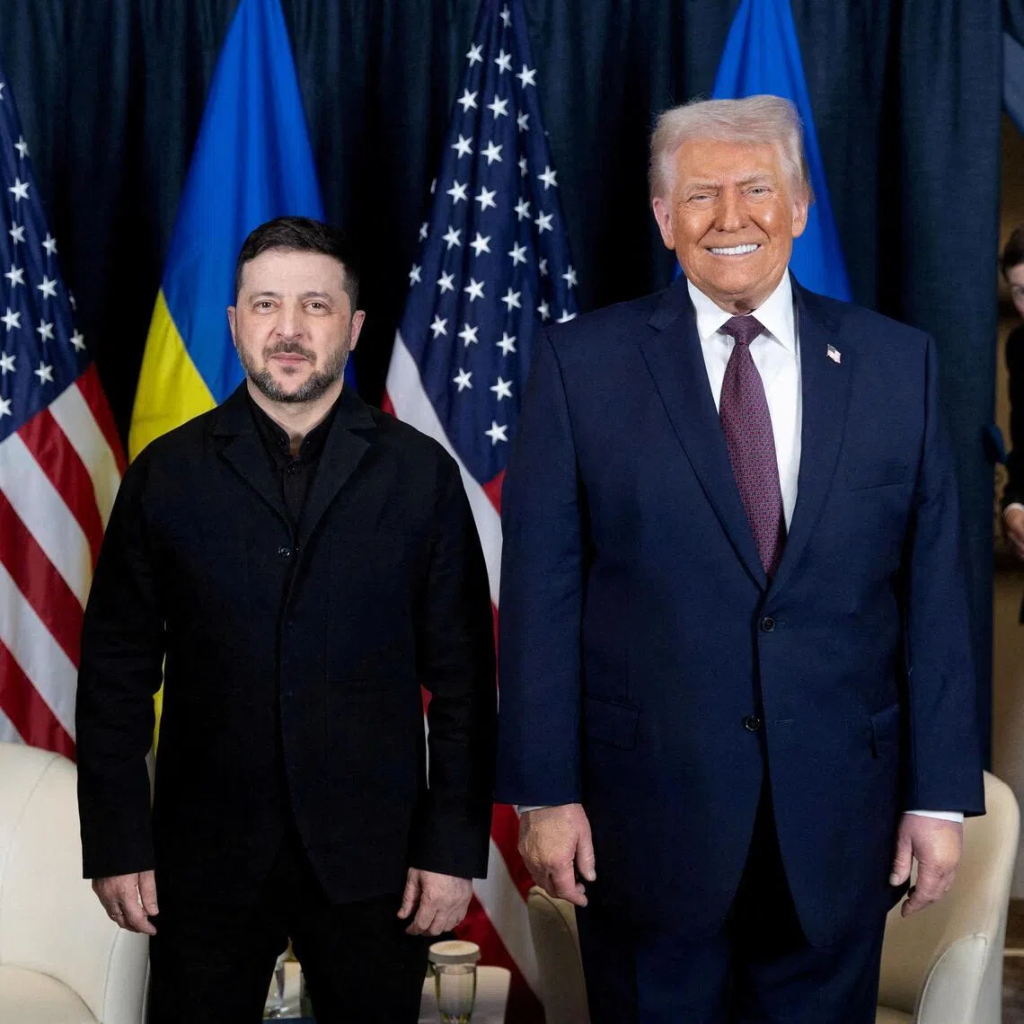 FILE PHOTO: Ukraine's President Volodymyr Zelenskiy and U.S. President Donald Trump pose for a picture during their meeting while Donald Trump's son-in-law Jared Kushner enters a room, at the sidelines of the 56th annual World Economic Forum (WEF), in Davos, Switzerland, January 22, 2026. Ukrainian Presidential Press Service/Handout via REUTERS ATTENTION EDITORS - THIS IMAGE HAS BEEN SUPPLIED BY A THIRD PARTY./File Photo