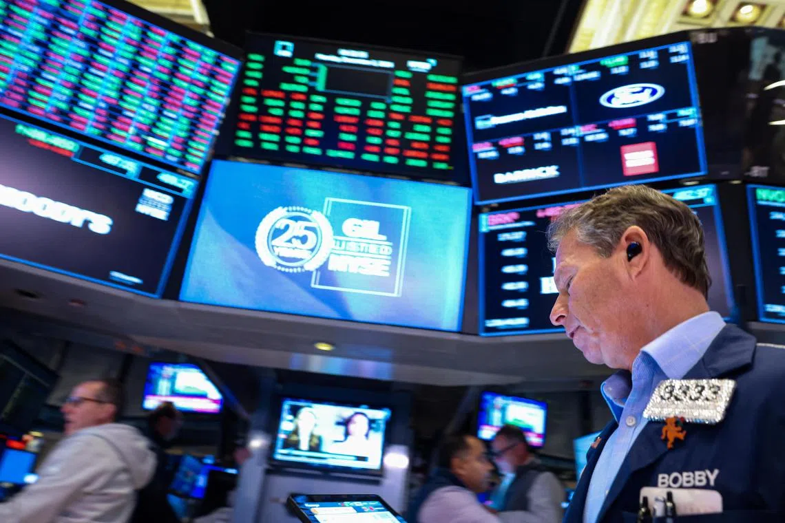 Traders work on the floor of the New York Stock Exchange, in New York City.