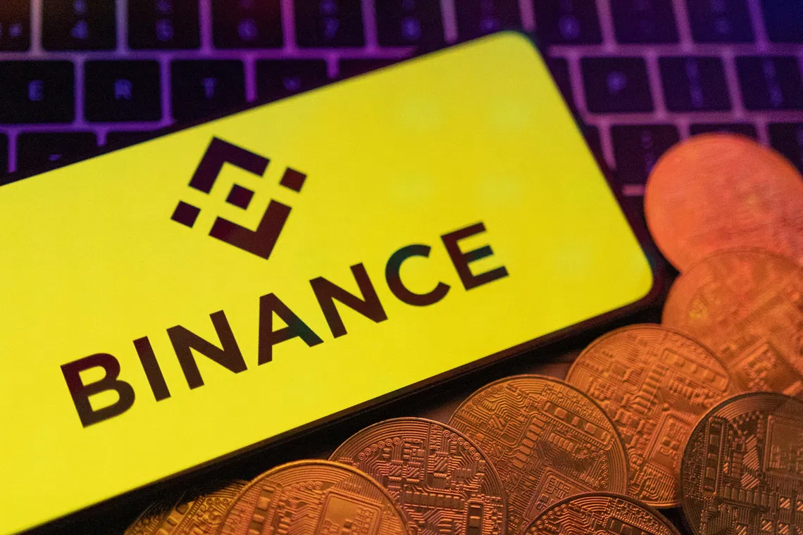 Smartphone with displayed Binance logo and representation of cryptocurrencies are placed on a keyboard in this illustration taken, June 8, 2023. REUTERS/Dado Ruvic/Illustration