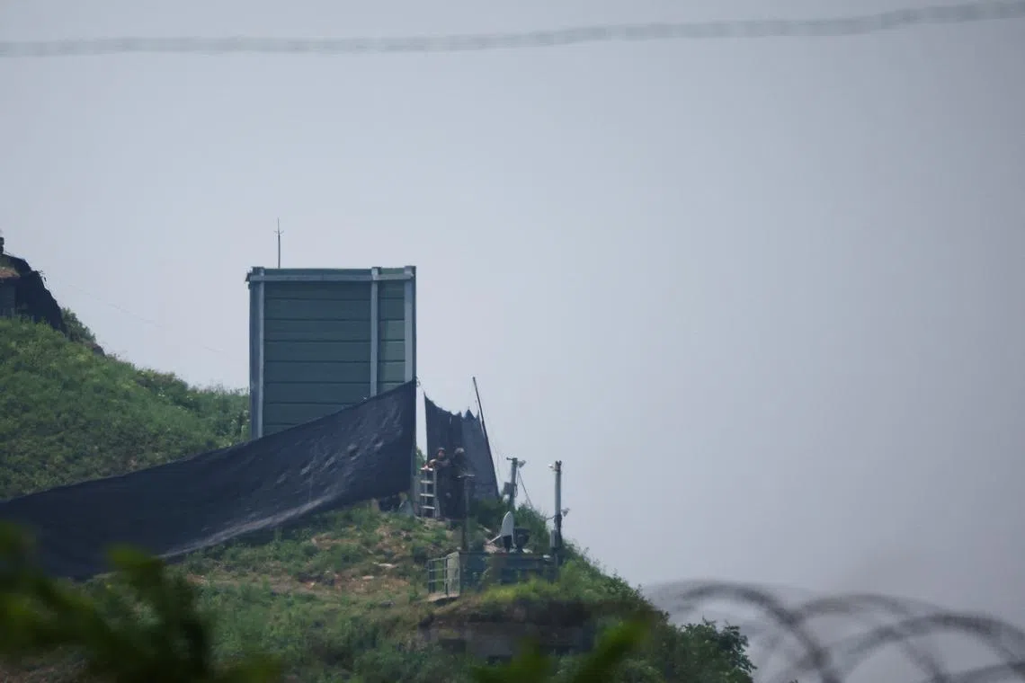 FILE PHOTO: South Korean soldiers work next to a military facility (Green box) where loudspeakers dismantled in 2018 used to be, near the demilitarized zone separating the two Koreas in Paju, South Korea, June 10, 2024. REUTERS/Kim Hong-Ji/File Photo